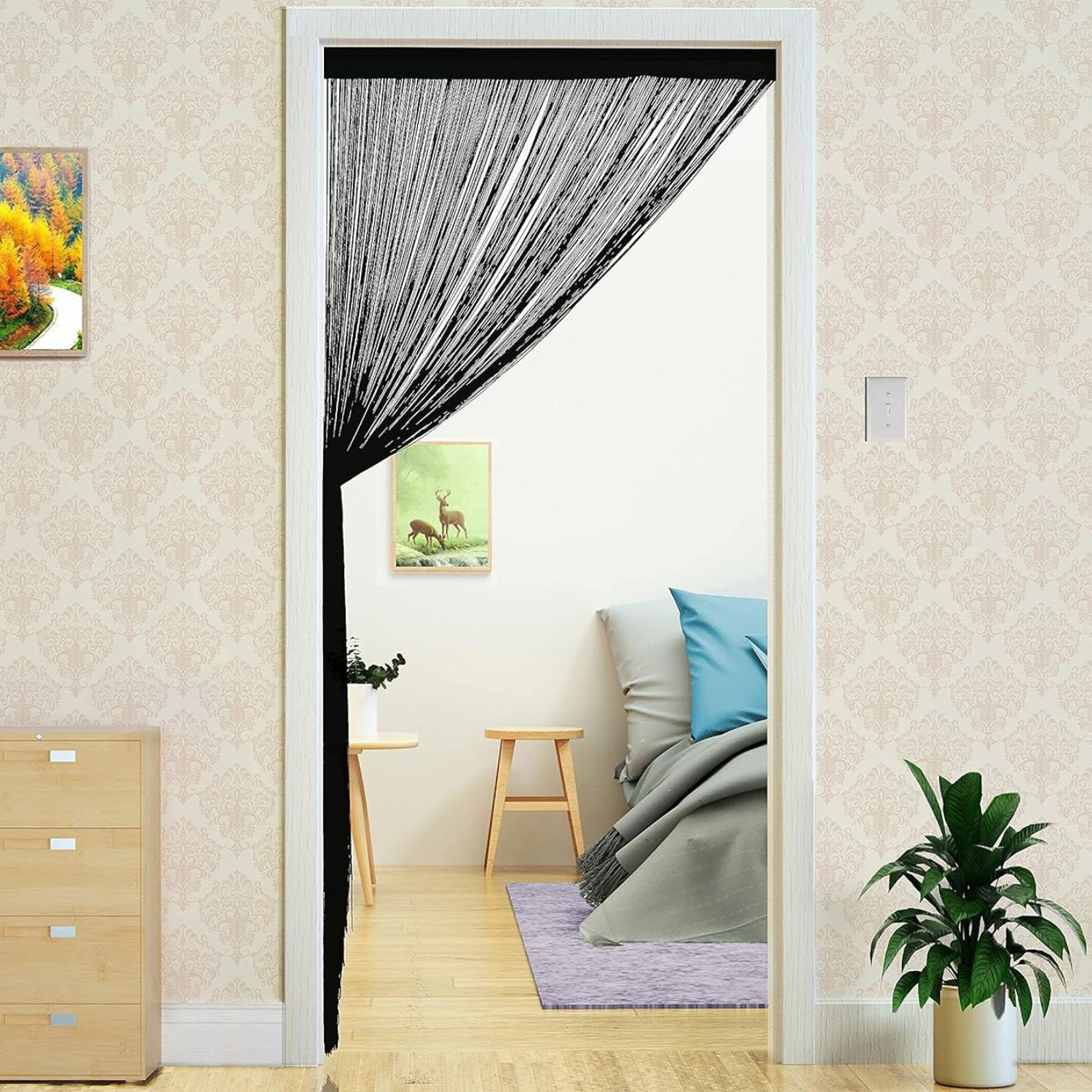 A black string curtain door hanging in an open doorway
